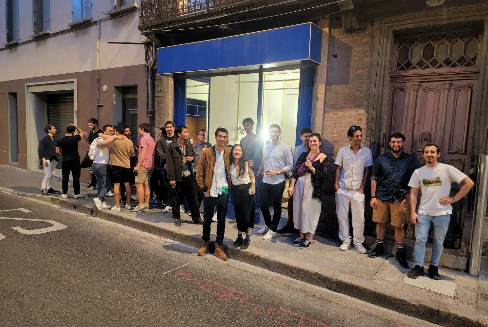 The team and friends celebrating outside the new office